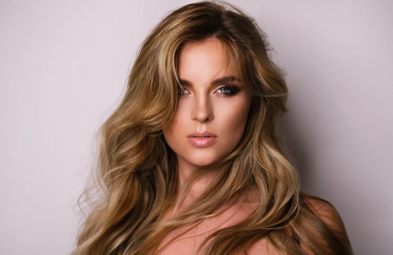 Imagen de una mujer módelo profesional de pelo largo luciendo un peinado con mechas Balayage en tonos dorados